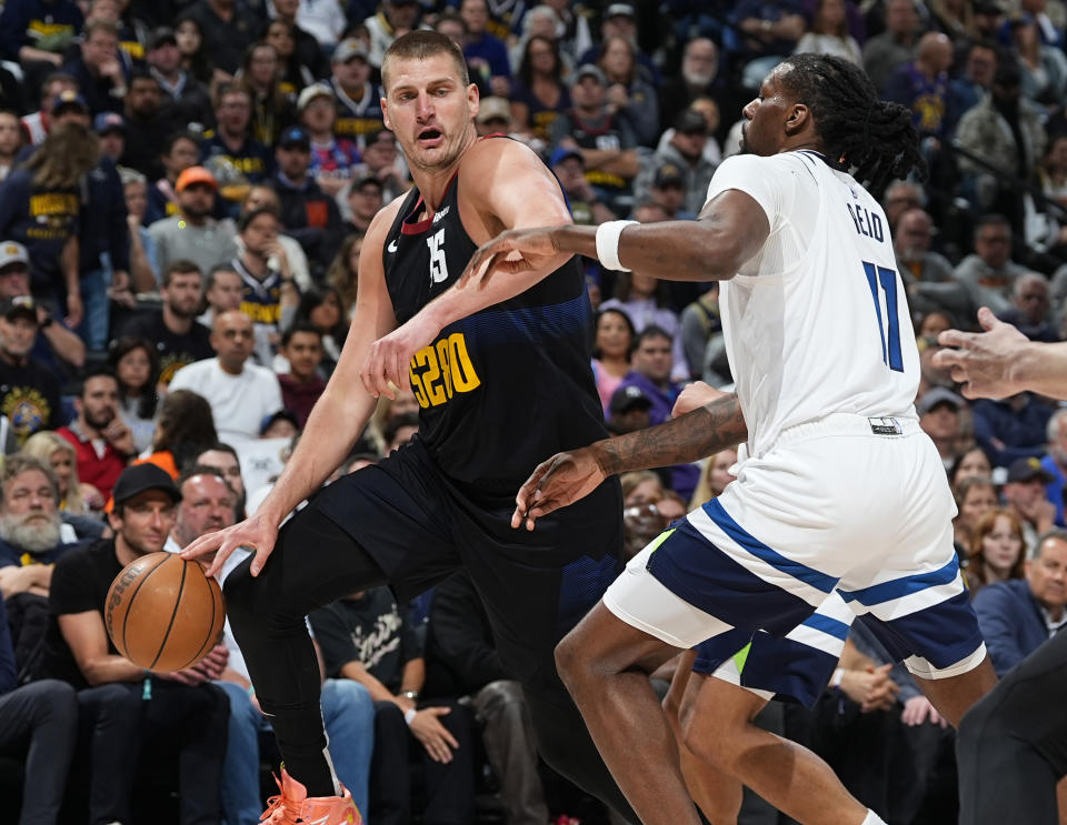 Denver Nuggets center Nikola Jokic, left, drives to the basket as Minnesota Timberwolves center Naz Reid, rright, defends in the first half of Game 2 of an NBA basketball second-round playoff series Monday, May 6, 2024, in Denver. (AP Photo/David Zalubowski)