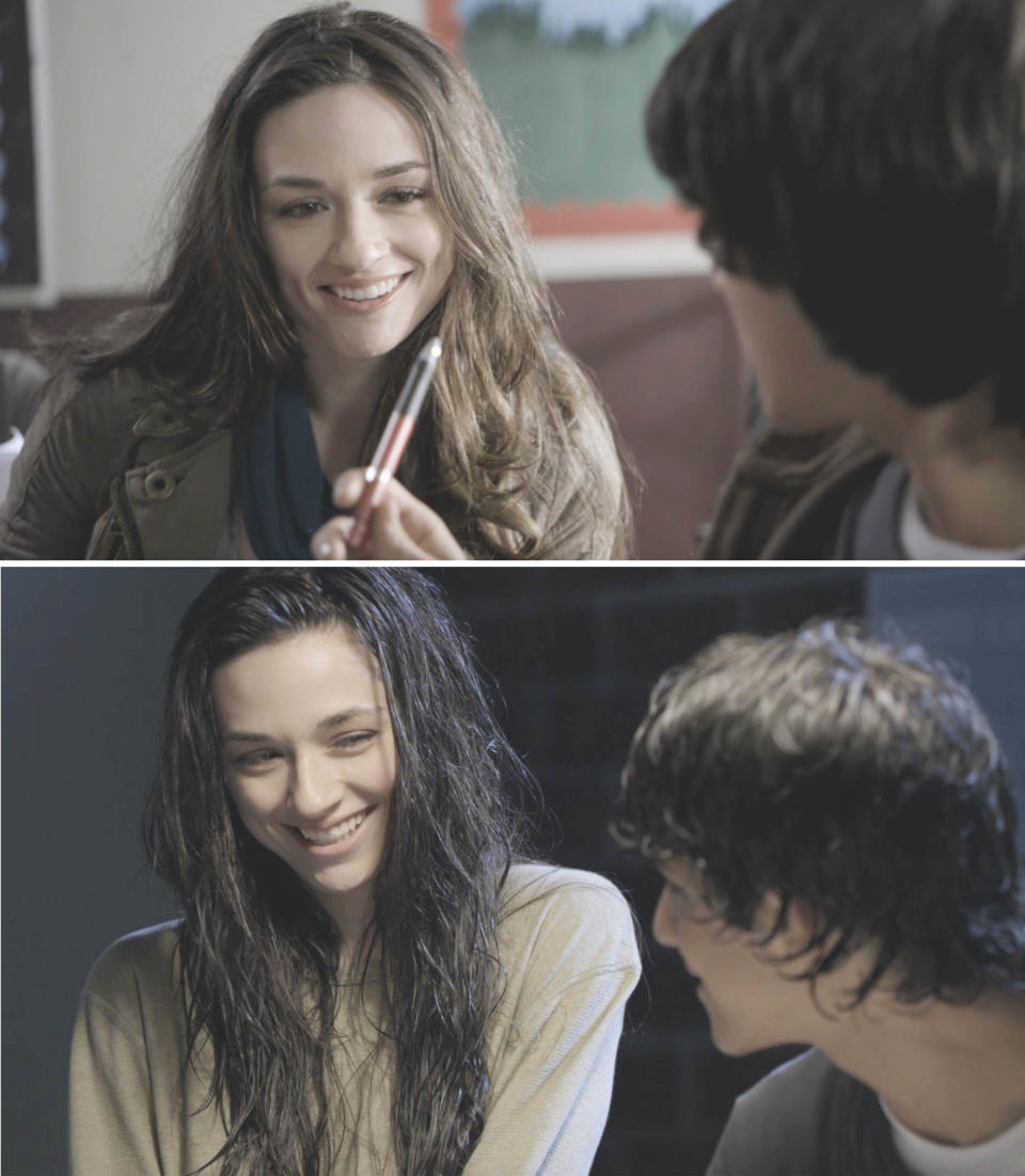 Allison smiling and sitting next to a guy