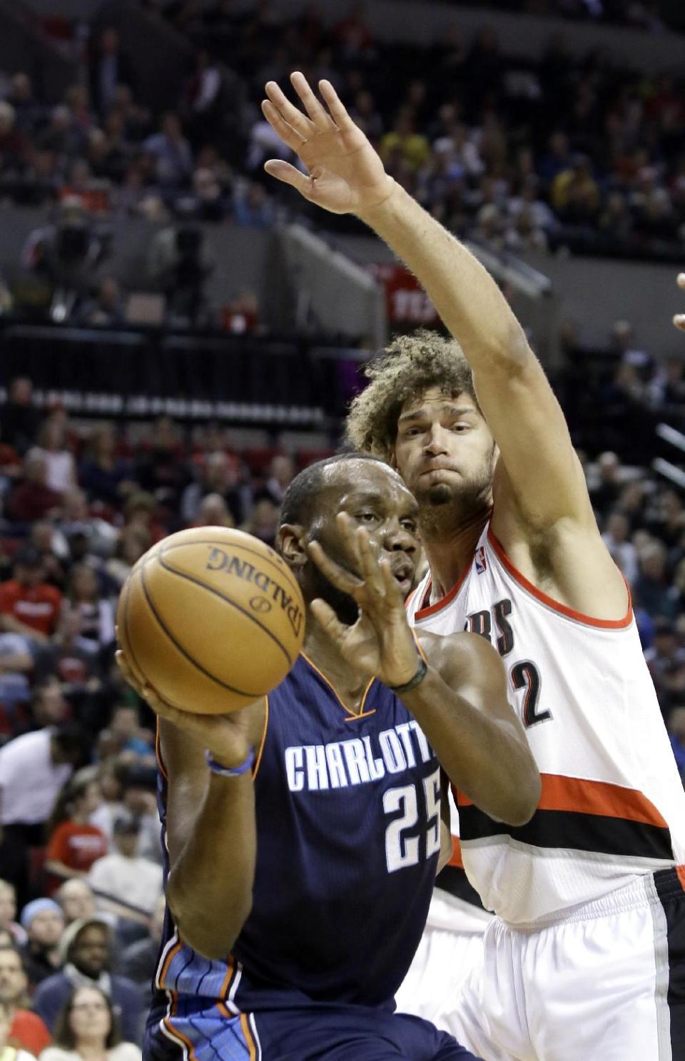 Charlotte Bobcats center Al Jefferson, left, passes off as Portland Trails Blazers center Robin Lopez defends during the first half of an NBA basketball game in Portland, Ore., Thursday, Jan. 2, 2014. (AP Photo/Don Ryan)