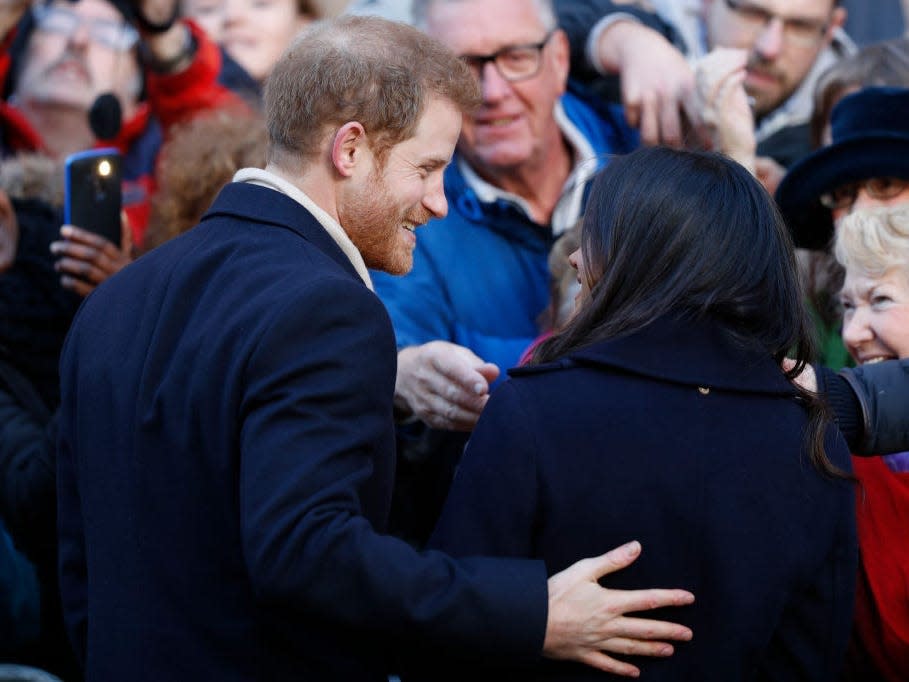 Prince Harry and Meghan Markle visit Nottingham Contemporary. Harry has his arm around Meghan.