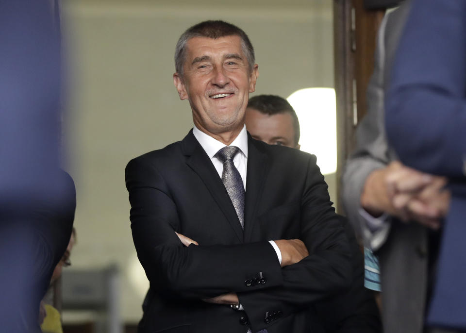 Czech Republic's Prime Minister Andrej Babis smiles as he waits to deliver a speech to honor the victims of the Soviet-led invasion of Czechoslovakia in 1968 at a ceremony in Prague, Czech Republic, Tuesday, Aug. 21, 2018. Dozens of protesters gathered to oppose the prime minister. Babis, a populist billionaire, is a controversial figure for many due to a power-sharing deal with the maverick Communist Party and fraud charges he is facing. His position is also complicated by allegations he collaborated with the former communist-era secret police. (AP Photo/Petr David Josek)