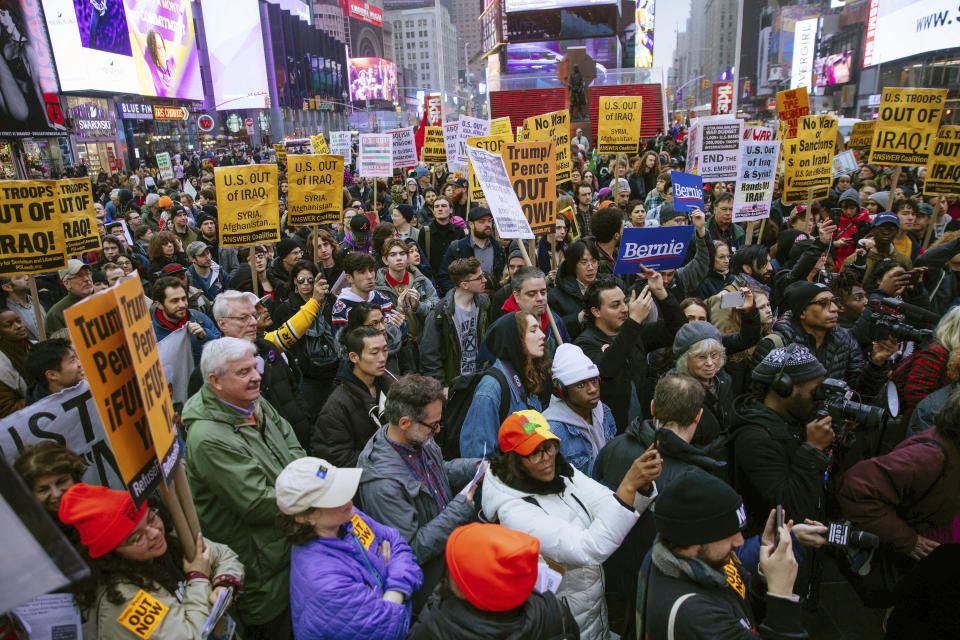 Activists gather in Times Square to protest recent U.S. military actions in Iraq on Saturday, Jan. 4, 2020, in New York. A top Iranian general and Iraqi militiamen were killed in a U.S. airstrike that sharply escalated tensions across the region. (AP Photo/Kevin Hagen).