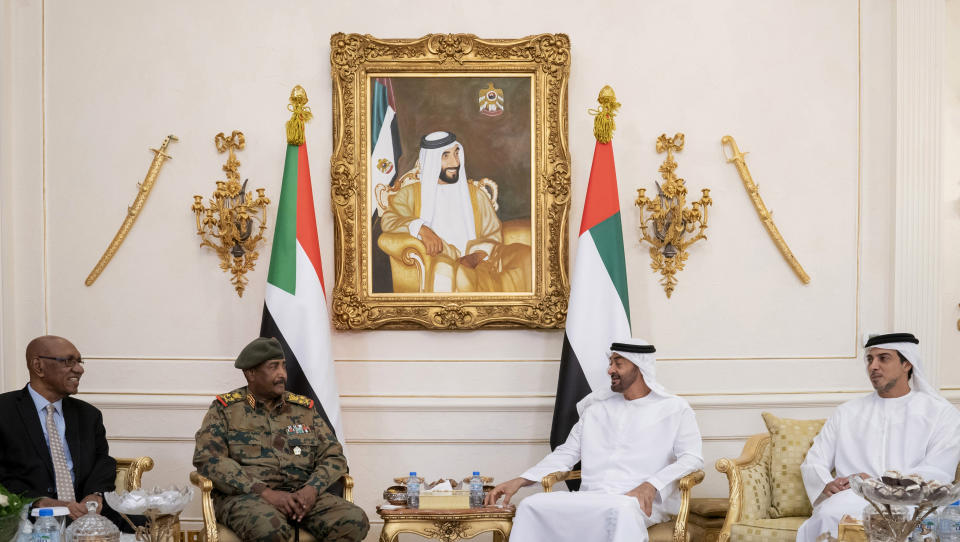 In this Sunday, May 26, 2019 photo made available Monday, May 27, by Ministry of Presidential Affairs, Sheikh Mohamed bin Zayed Al Nahyan, Crown Prince of Abu Dhabi and Deputy Supreme Commander of the UAE Armed Forces, second right, receives Lieutenant General Abdel Fattah Al Burhan Abdelrahman, Head of transitional military council of Sudan, second left, with the presence of Sheikh Mansour bin Zayed Al Nahyan, UAE Deputy Prime Minister and Minister of Presidential Affairs, at the Presidential Airport in Abu Dhabi, United Arab Emirates. (Mohamed Al Hammadi/Ministry of Presidential Affairs via AP)