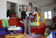 <h2>Burping babies in Rome</h2>Francesca Baldi, 32, poses for a picture as she takes care of a seven month-old baby in a private household in Rome May 11, 2012. Baldi studied for five years at university in Pisa where she received a degree and a doctorate in literature and philosophy. She hoped to find a job as a teacher but has been working as a childminder for five months.