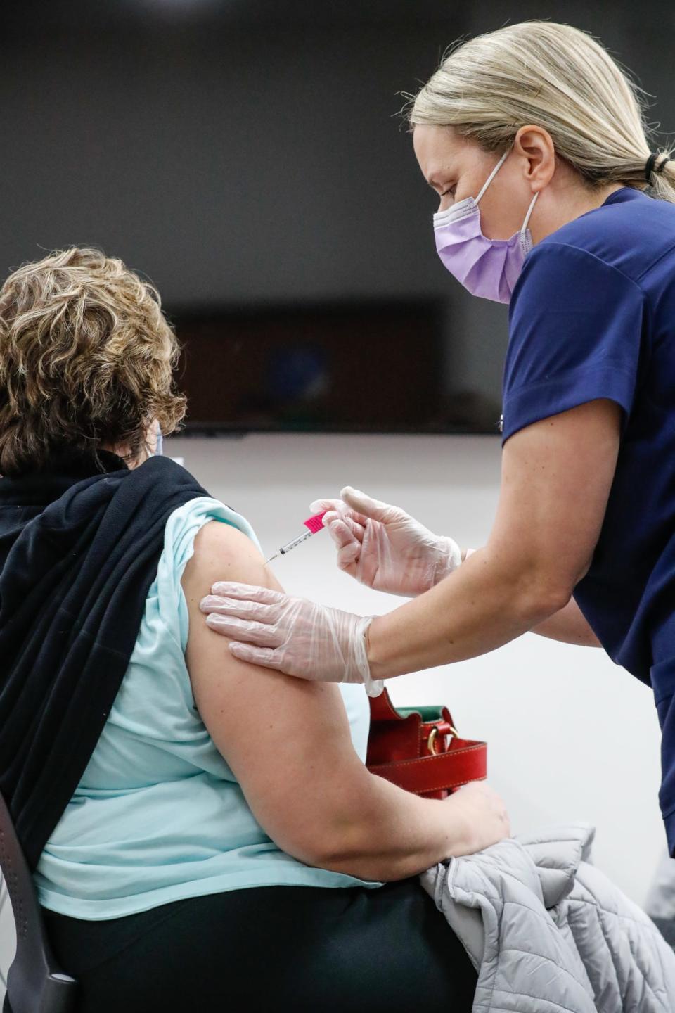 Nursing student Brandi White, right, injects Rita Langlois with the Pfizer vaccine at Ascension St. Vincent William K. Nasser, MD, Healthcare Education, and Simulation Center, 1801 W. 86th Street, Indianapolis, on Saturday, Jan. 16, 2021. 