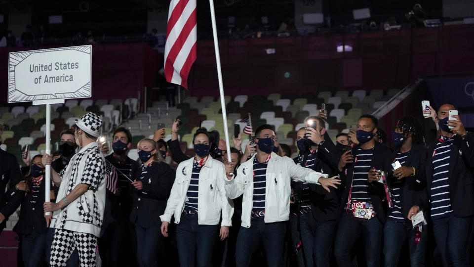 <p>Sue Bird and Eddy Alvares, of the United States of America, carry their country's flag during the opening ceremony in the Olympic Stadium at the 2020 Summer Olympics, Friday, July 23, 2021, in Tokyo, Japan. (AP Photo/Natacha Pisarenko)</p> 