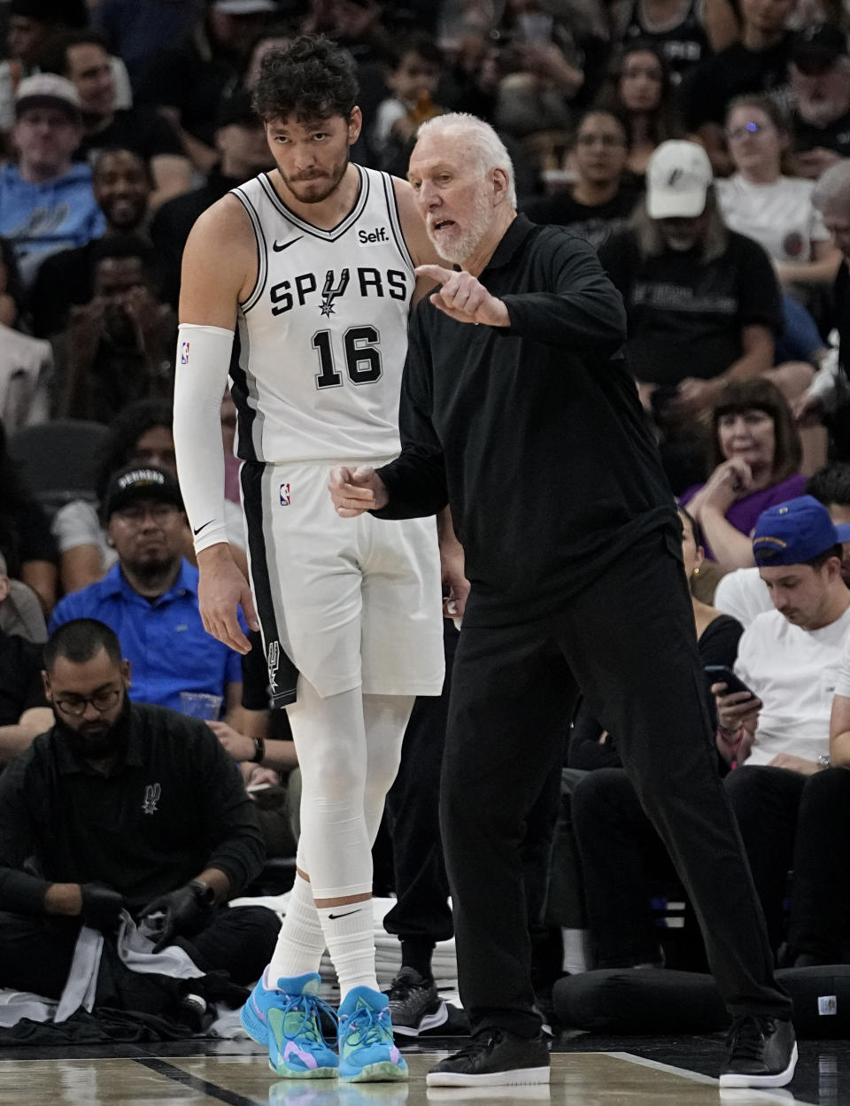 San Antonio Spurs coach Gregg Popovich, right, gives instruction to forward Cedi Osman (16) during the second half of the team's preseason NBA basketball game against the Miami Heat in San Antonio, Friday, Oct. 13, 2023. (AP Photo/Eric Gay)