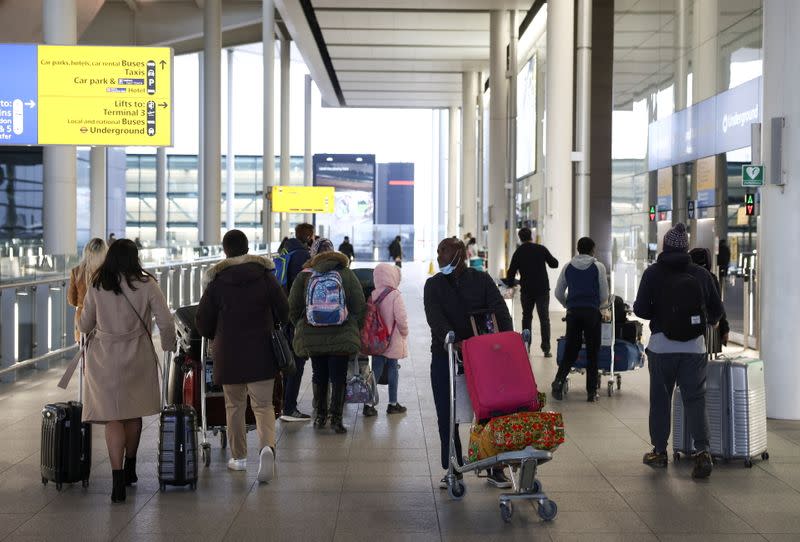 Travellers walk through Terminal 2 at Heathrow Airport, amid the coronavirus disease (COVID-19) outbreak in London