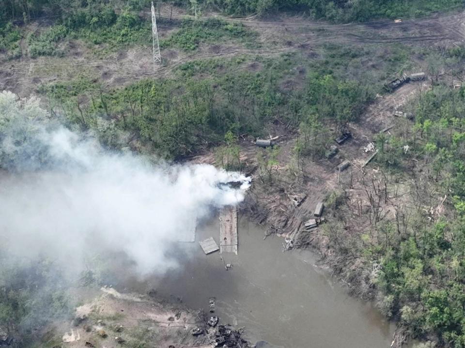 Destroyed pontoon bridges and armored vehicles on the Siverskyi Donets River in eastern Ukraine