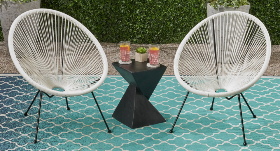 white patio chairs on blue outdoor rug and black side table from wayfair way day sale