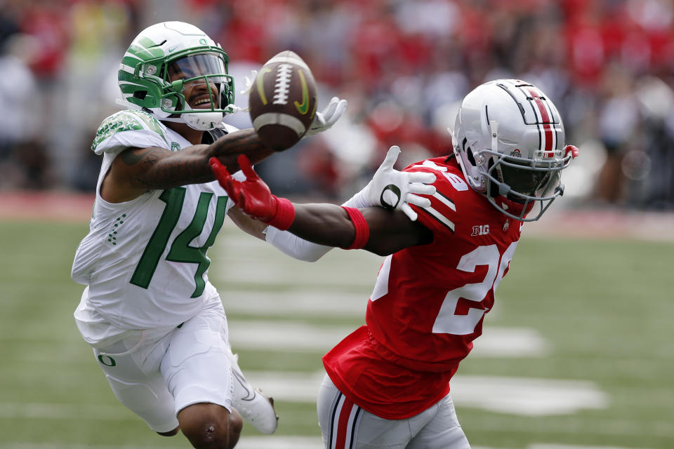 Ohio State defensive back Denzel Burke, right, breaks up a pass intended for Oregon receiver Kris Hutson during the first half of an NCAA college football game Saturday, Sept. 11, 2021, in Columbus, Ohio. (AP Photo/Jay LaPrete)