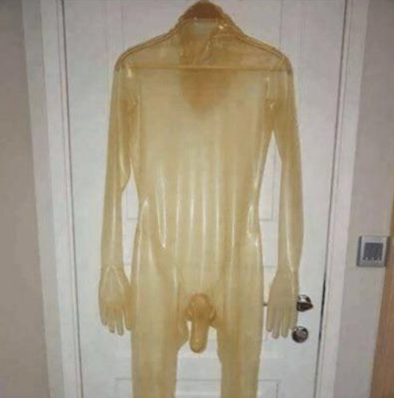 Translucent latex bodysuit with gloves and attached condom hanging on a door