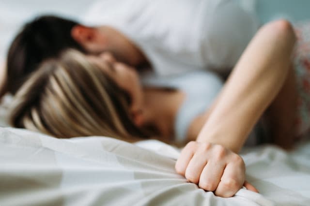 Portrait of young loving couple in bedroom