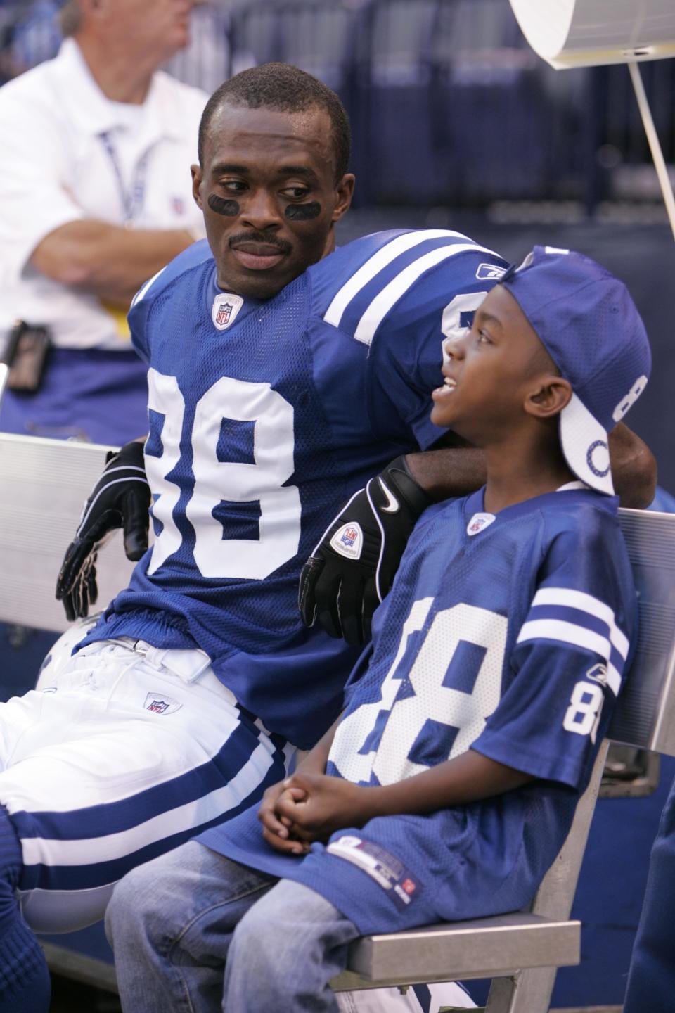 Marvin Harrison chats with his son, Marvin Jr. on the sidelines near the end of the game.  Baltimore Ravens at Indianapolis Colts, Lucas Oil Stadium, Indianapolis, IN, October 12, 2008.   Colts won 31-3.