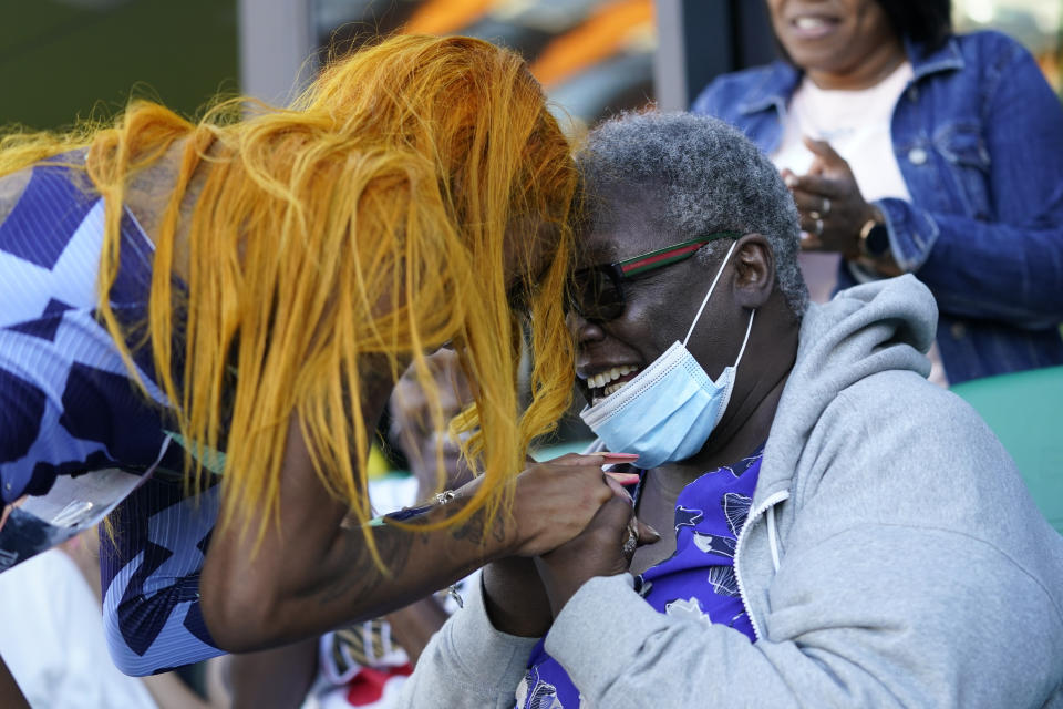 Sha'Carri Richardson celebrates after winning the women's 100-meter run with grandmother Betty Harp at the U.S. Olympic Track and Field Trials Saturday, June 19, 2021, in Eugene, Ore. (AP Photo/Ashley Landis)