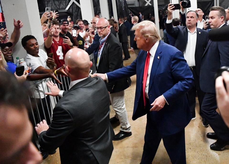 Sep 28, 2024; Tuscaloosa, Alabama, USA; Former president and current Republican nominee for president Donald J. Trump visits Bryant-Denny Stadium for the football game between Alabama and Georgia. Trump passes out concession stand food to fans. Mandatory Credit: Gary Cosby Jr.-Imagn Images