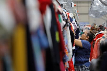 A quality control worker hang clothing at Rent the Runway's "Dream Fulfillment Center" in Secaucus, New Jersey