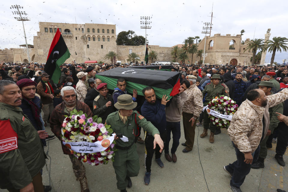 Mourners carry coffins during a funeral of military cadets in Tripoli, Libya, Sunday, Jan. 5, 2020. Health officials said the death toll from the airstrike climbed to at least 30 people, most of them students and over 30 others were wounded. The airstrike took place in the city's south late Saturday, an area which has seen heavy clashes in recent months. Forces based in eastern Libya and led by Gen. Khalifa Hifter have been fighting to seize the capital from the weak but U.N.-supported government. (AP Photo/Hazem Ahmed)