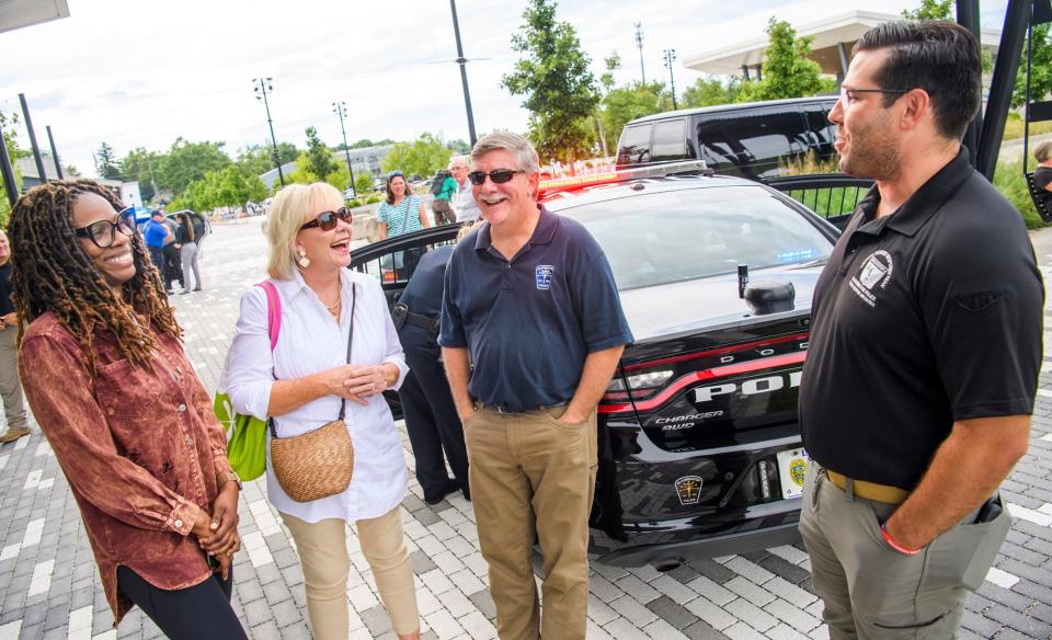 Shatoyia Moss, Mary Catherine Carmichael, Chief Michael Diekhoff and Sgt. Shawn Hines share a laugh during the National Night Out event at Switchyard Park last year.