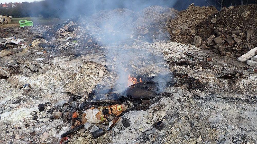 A small fire burning at the site