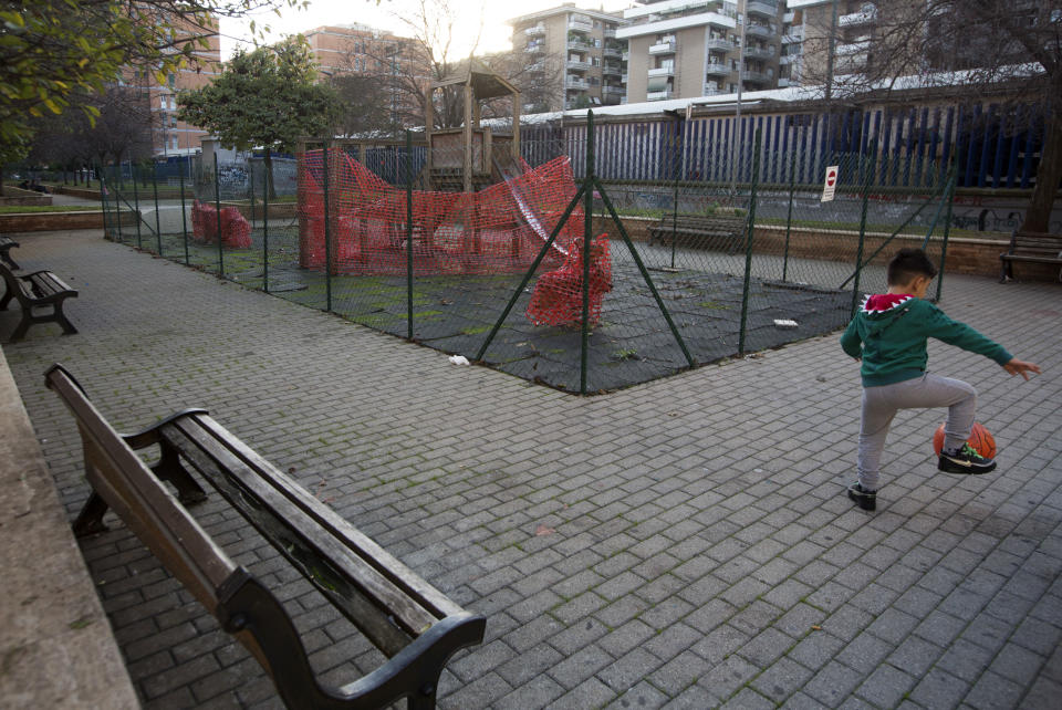 A child plays in front of a closed rundown playground in Rome's Magliana neighborhood, Thursday, Nov. 8, 2018. Rome’s monumental problems of garbage and decay exist side-by-side with Eternal City’s glories. (AP Photo/Alessandra Tarantino)
