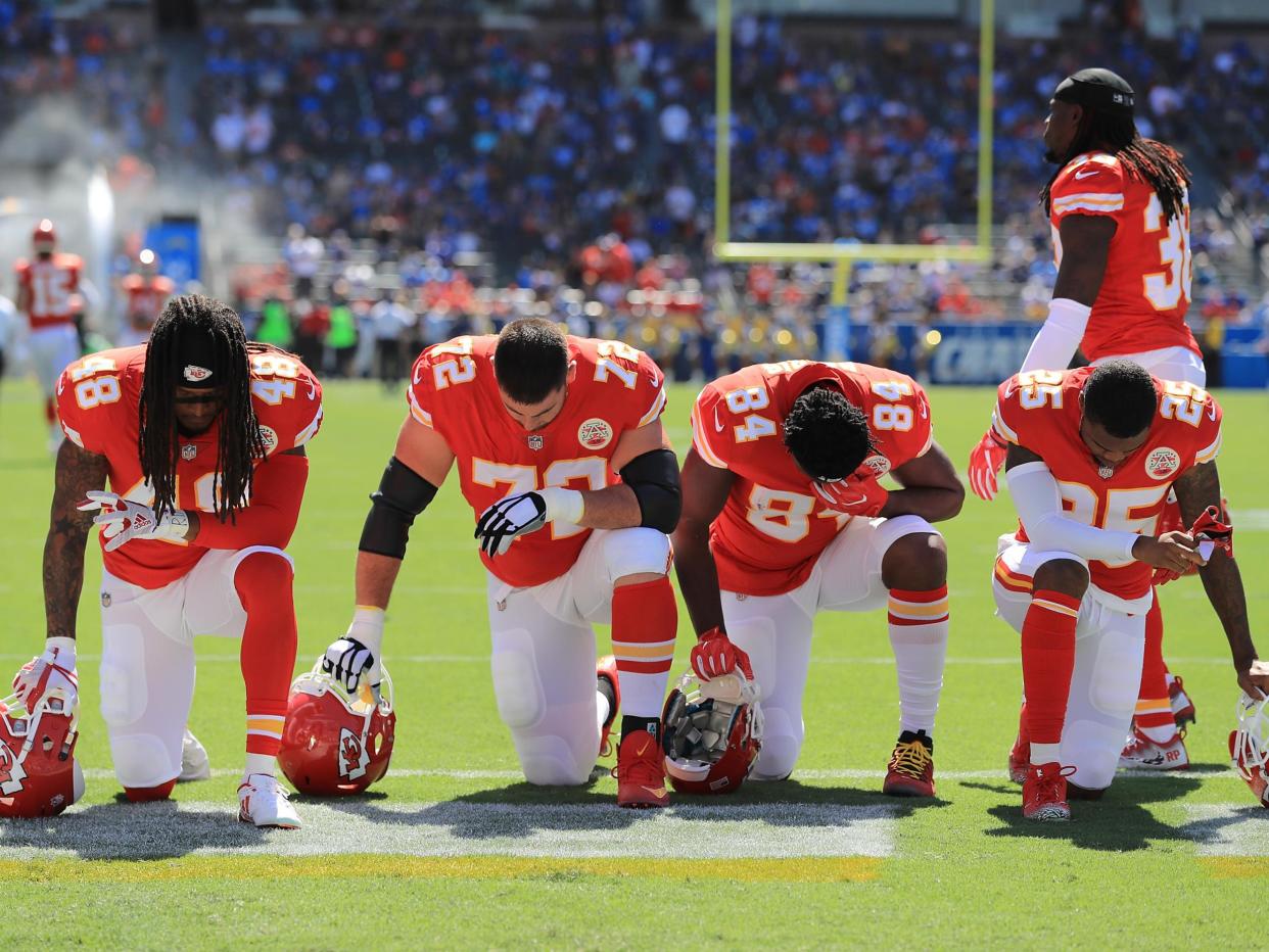 Terrance Smith #48, Eric Fisher #72, Demetrius Harris #84, and Cameron Erving #75 of the Kansas City Chiefs is seen taking a knee before the game against the Los Angeles Chargers at the StubHub Center on 24 September, 2017 in Carson, California: Sean M. Haffey/Getty