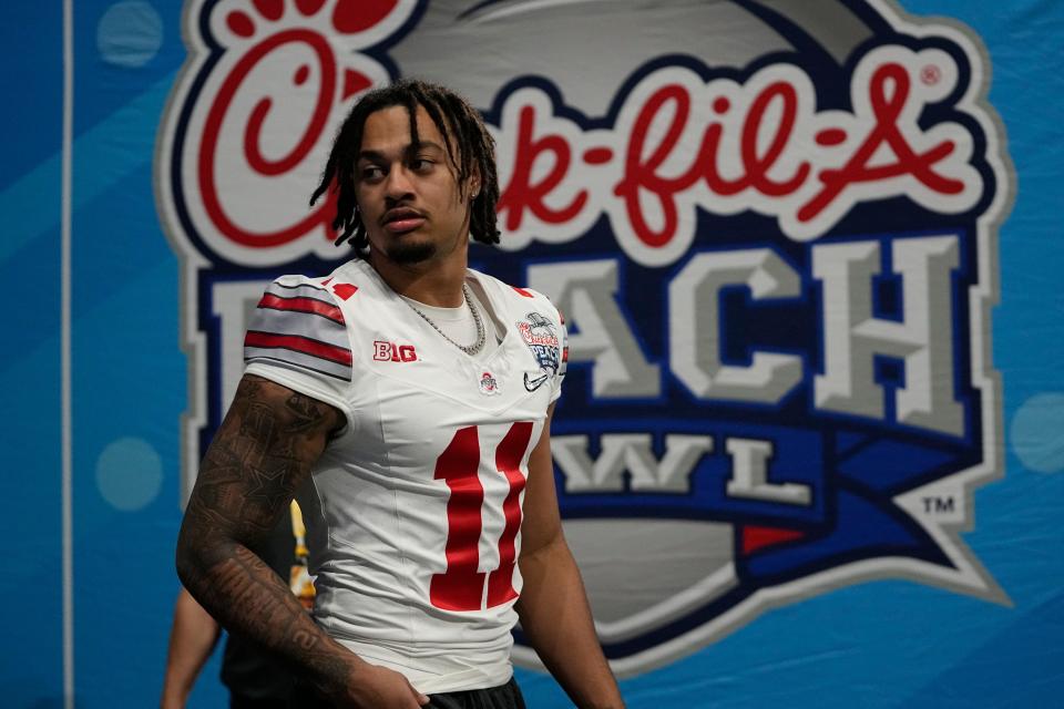 Dec 31, 2022; Atlanta, Georgia, USA;  Ohio State Buckeyes wide receiver Jaxon Smith-Njigba (11) walks onto the field prior to the Peach Bowl in the College Football Playoff semifinal at Mercedes-Benz Stadium. Smith-Njigba did not play due to injury. Mandatory Credit: Adam Cairns-The Columbus Dispatch