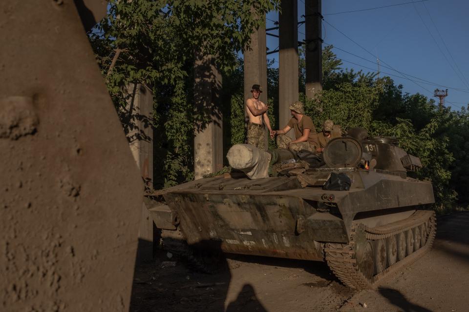 Ukrainian soldiers rest on an armoured military vehicle (AFP via Getty Images)