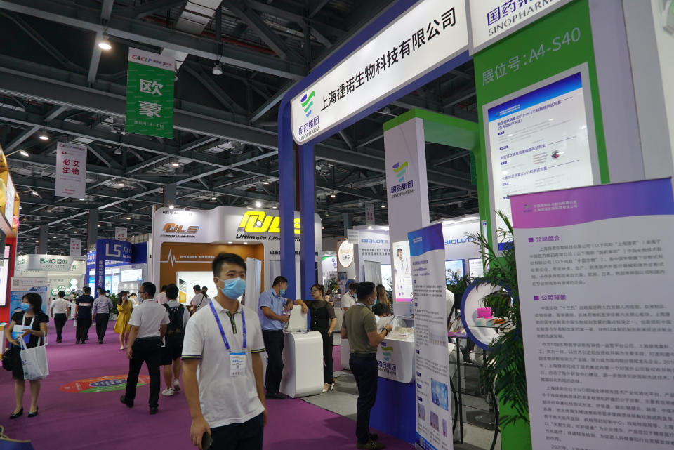 Shanghai-based testing kit company GeneoDx presents a booth at a trade fair in Nanchang in eastern China's Jiangxi province on Saturday, Aug. 22, 2020. GeneoDx was one of three companies that gained privileged access to crucial information on the coronavirus from the Chinese Center for Disease Control and Prevention at the beginning of the outbreak, allowing them to make kits ahead of competitors. The move delayed China's response to the outbreak and caused critical shortages of kits. (AP Photo/Dake Kang)