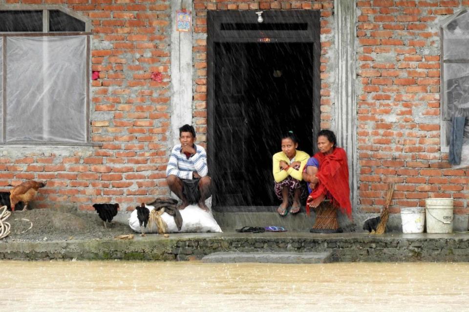 Residents look out from their homes in a flooded area of Sauraha, Chitwan district (AFP/Getty Images)