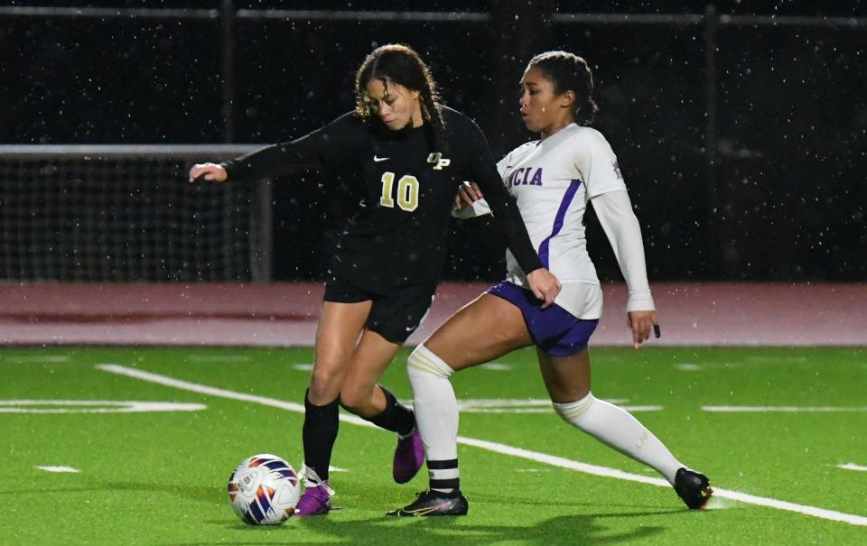 Oak Park's Malea Johnson tries to fend off a Valencia defender during the Eagles' 2-0 victory in a CIF-Southern Section Division 3 wild-card match at Oak Park High on Tuesday, Feb. 6, 2024.