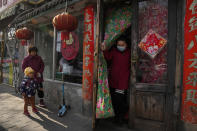 A customer wearing a mask leaves from a dumplings restaurant in Beijing, China on Dec. 21, 2021. Caseloads of omicron have remained relatively low in many countries in Asia. For now, many remain insulated from the worst, although the next few months will remain critical. (AP Photo/Ng Han Guan)