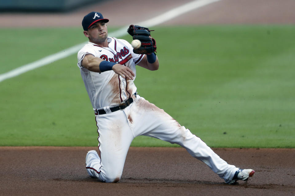 Atlanta Braves third baseman Austin Riley (27) throw to first after fielding a ball hit for a single by Toronto Blue Jays' Teoscar Hernandez in the first inning of a baseball game Tuesday, Aug. 4, 2020, in Atlanta. (AP Photo/John Bazemore)