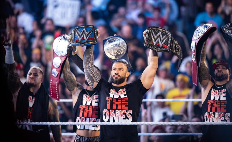 WORCESTER - Roman Reigns and The Usos raise their respective championship titles in the ring during "WWE Friday Night SmackDown" at the DCU Center, Friday, Oct. 7, 2022.