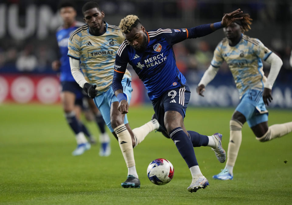 FC Cincinnati forward Aaron Boupendza (9) and Philadelphia Union defender Damion Lowe (17) vie for the ball during the first half of an MLS Eastern Conference semifinal soccer match Saturday, Nov. 25, 2023, in Cincinnati. (AP Photo/Carolyn Kaster)