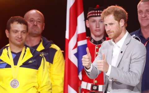 Prince Harry walks on the stage during the closing ceremony for the Invictus Games in Toronto - Credit: Reuters