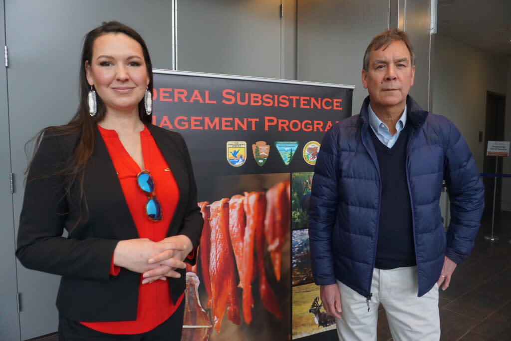 Raina Thiele, senior advisor to Interior Secretary Deb Haaland for Alaska affairs and strategic priorities, and Bob Anderson, solicitor for the Department of the Interior, stand on March 5, 2024, by the entrance to the annual All-Council meeting of the state's 10 subsistence regional advisory councils. The four-day meeting is being held at the Dena'ina Civic and Convention Center in Anchorage. (Photo by Yereth Rosen/Alaska Beacon)