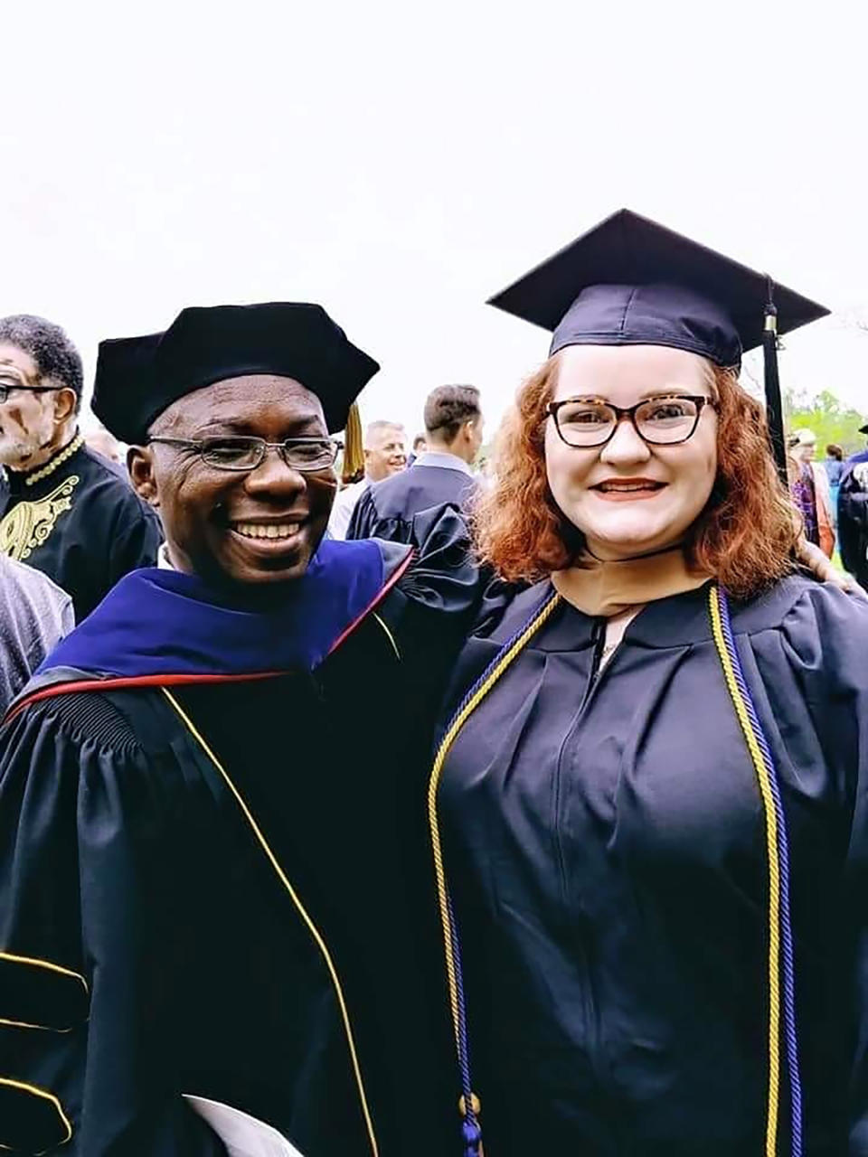 In this photo provided by Sydnee Shipley, Sydnee poses for a photo with science professor Steve Opoku-duah at her 2018 graduation from Ohio Valley University in Vienna, W.Va. Shipley, who officially graduated in 2019 but walked with the 2018 class, is part of a group of former Ohio Valley students trying to advocate for access to transcript records, which the school said were deleted from its database after the system was hacked following the announcement of its closure in December 2021. (Sydnee Shipley via AP)