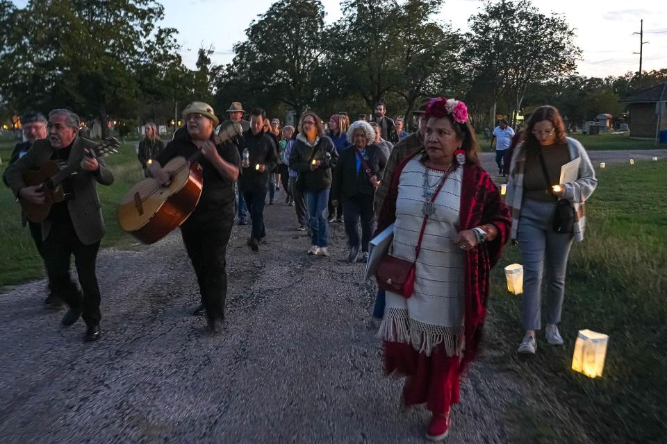 Hermelinda Zamarripa, right, leads a group of visitors to her extended family's ofrenda during the Alma y Corazon event. “Their strength and resilience lives through us,” she said of ancestors. “It has empowered us through turbulent times.”