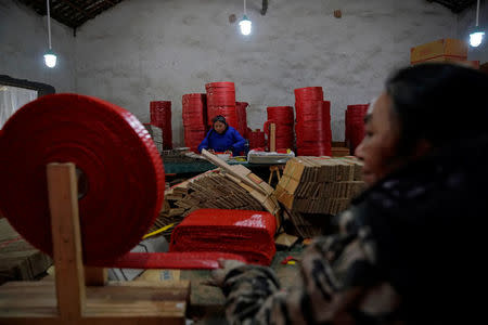 Workers process pyrotechnic product at Xiang Shun firecrackers fireworks factory in Liuyang, Hunan province, China January 30, 2018, Picture taken January 30, 2018. REUTERS/Aly Song