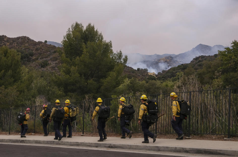 A firefighting crew moves closer to a wildfire in the Pacific Palisades area of Los Angeles, Sunday, May 16, 2021. A smoky wildfire churning through the Los Angeles canyon community gained strength Sunday as about a thousand residents remained under evacuation orders while others were warned they should get ready to leave. (AP Photo/Ringo H.W. Chiu)