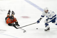 Anaheim Ducks left wing Max Comtois, left, dives for the puck as Tampa Bay Lightning left wing Alex Killorn reaches for it during the first period of an NHL hockey game Friday, Jan. 21, 2022, in Anaheim, Calif. (AP Photo/Mark J. Terrill)