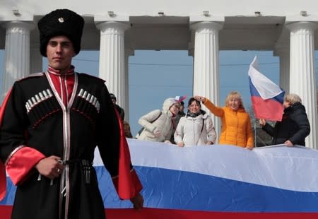 People attend a rally marking the second anniversary of Russia's annexation of Ukraine's Crimea region in the Black Sea port of Sevastopol, Crimea, March 18, 2016. REUTERS/Pavel Rebrov