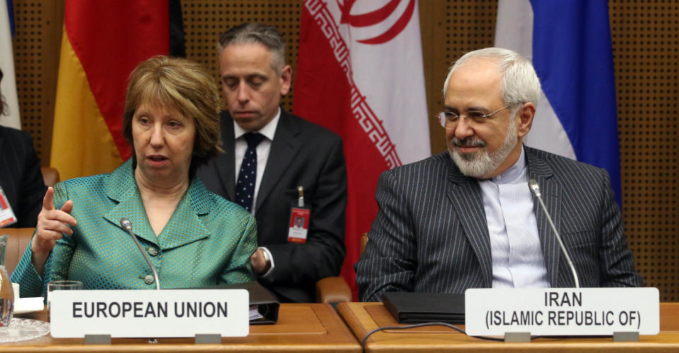 European Union foreign policy chief Catherine Ashton, left, and Iranian Foreign Minister Mohamad Javad Zarif, right, wait for the start of closed-door nuclear talks in Vienna, Austria, Tuesday, March 18, 2014. Ashton and Zarif have launched a new round of nuclear talks between Tehran and six world powers, putting a reported tiff behind them. The two sides hope to reach an agreement by July that trims Iran's nuclear activities in exchange for an end to sanctions choking Tehran's economy. (AP Photo/Ronald Zak)