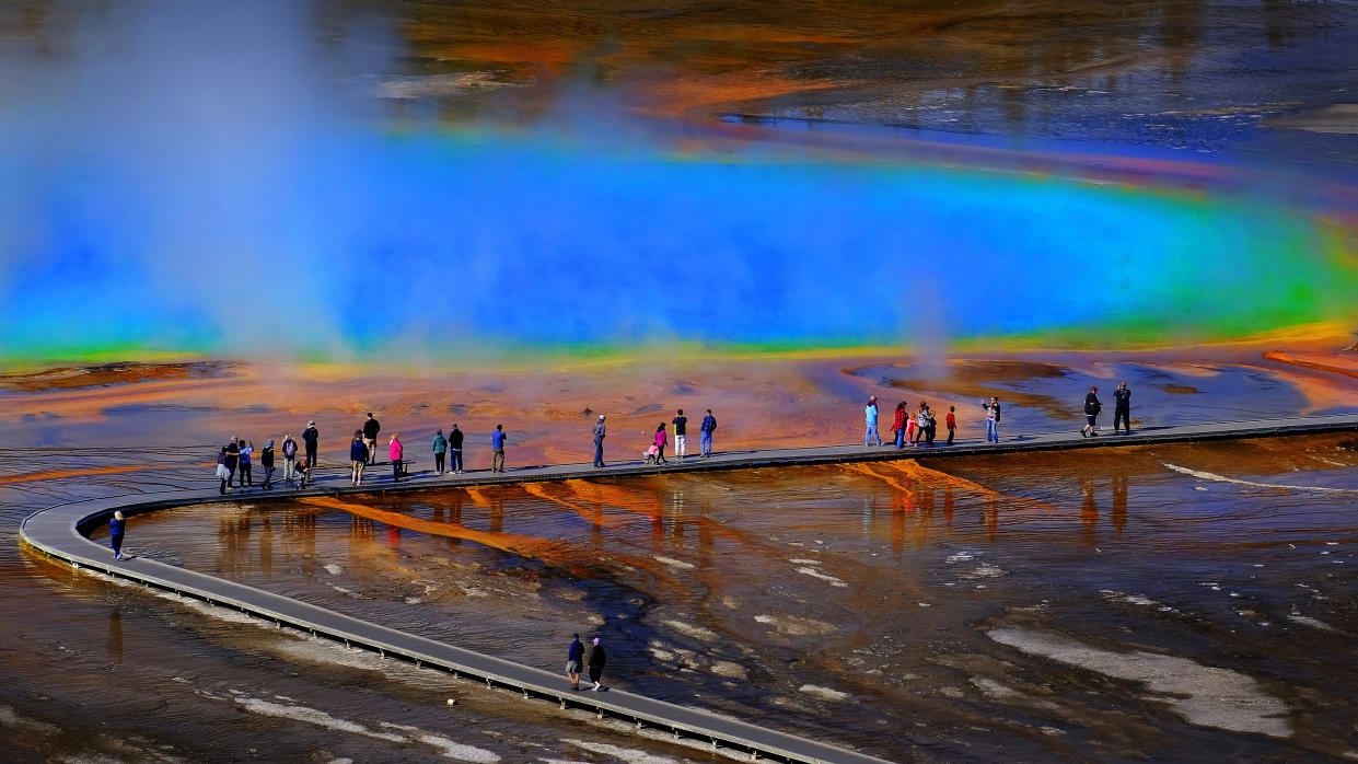  Hikers on boardwalk at Grand Prismatic, Yellowstone National Park, USA 