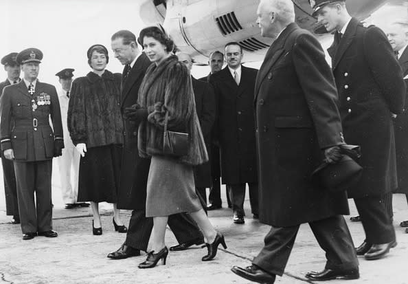 <p>Then Princess Elizabeth II and Prince Philip (right, wearing a hat) are accompanied by Harold Alexander, Governor General of Canada, as they arrive at Dorval Airport in Montreal. [Getty/ Paul Popper]<br></p>