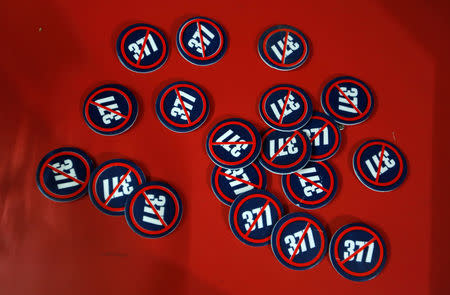 Badges against the Section 377 law of the Indian Penal Code are pictured on a table at the entrance of an NGO, in Mumbai, India, September 6, 2018. REUTERS/Francis Mascarenhas