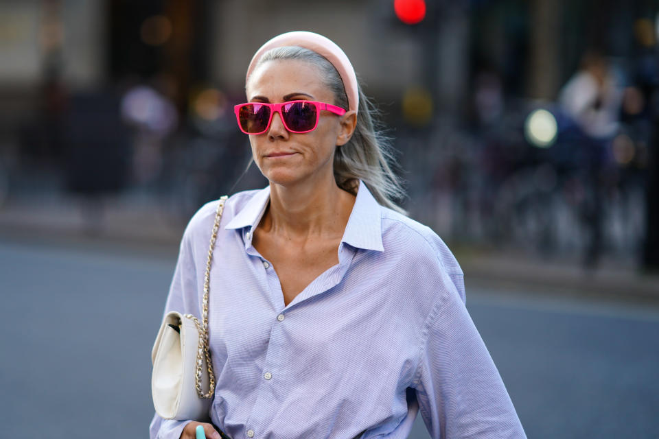 LONDON, ENGLAND - SEPTEMBER 13: A guest wears pink sunglasses, a pale purple shirt, a pink headband, during London Fashion Week September 2019 on September 13, 2019 in London, England. (Photo by Edward Berthelot/Getty Images)