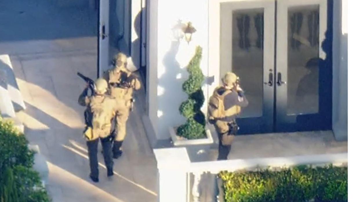 Newport Beach police officers searching a home