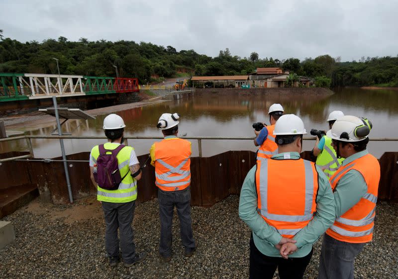 Workers from the Brazilian mining company Vale are seen near the Alberto Flores bridge in Brumadinho